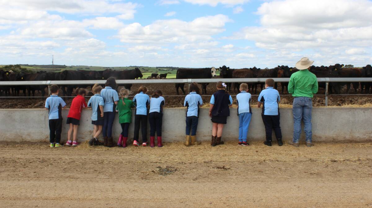 Young students visiting Iranda feedlot at Tintinara, SA, and manager Tom Green. PHOTO: Kelly Nankivell