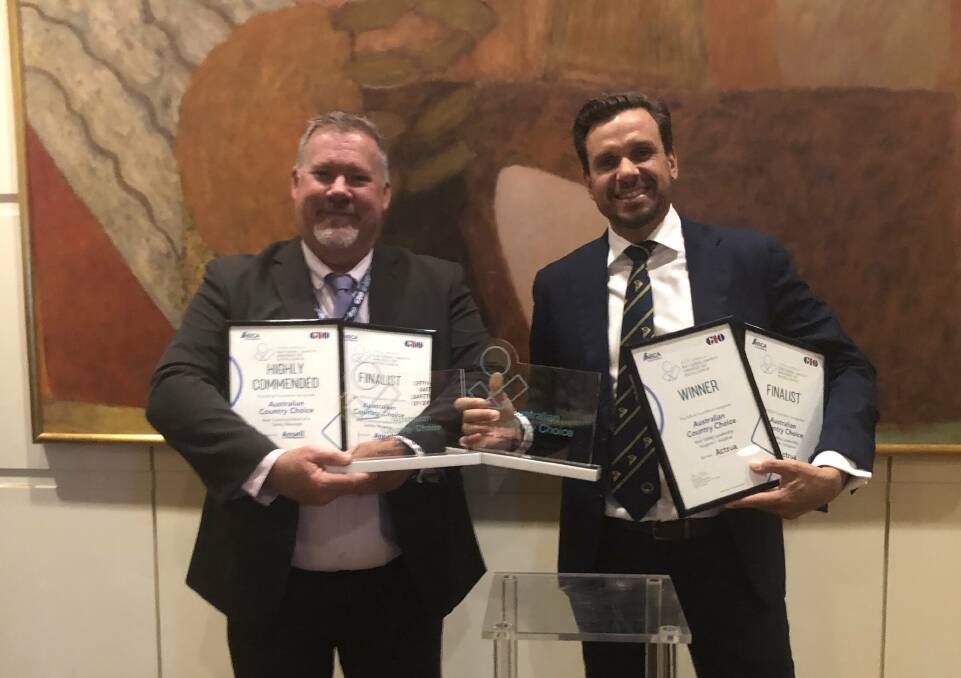 Holding their workplace safety awards are Australian Country Choice Group Program Manager Workplace Health and Safety Brett Porter and CEO Anthony Lee.