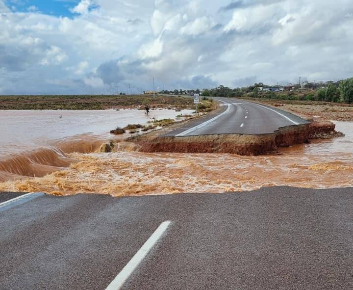 The Sturt Highway is cut in many places - here the highway is badly damaged at near Pimba. Picture: Spud's Roadhouse.
