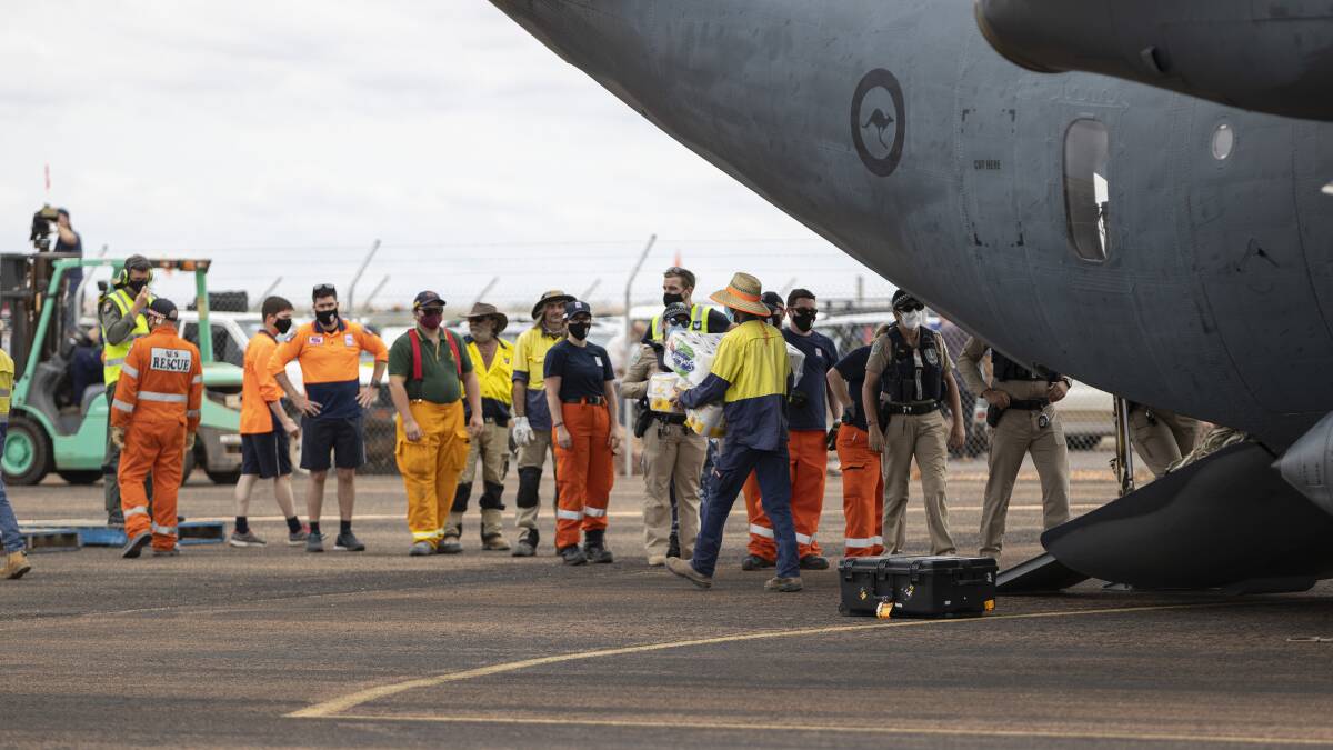 Emergency food supplies are offloaded at Coober Pedy Airport yesterday. Picture: RAAF.