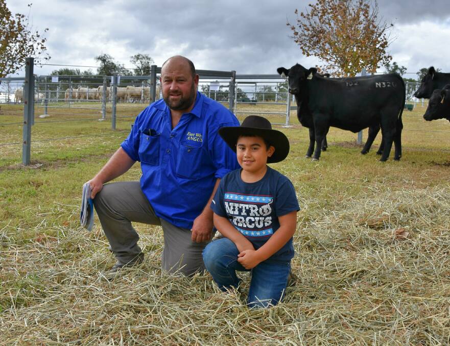 Shane Adams and son David, East West Angus, Upper Bingara, NSW with their $13,000 top price Angus hefier, Ascot Brenda N320.
