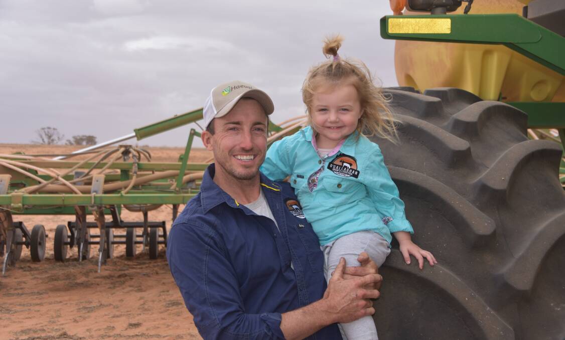 Ouyen farmer Adam O'Callaghan, with daughter Daisy, was dry sowing oats when pictured but is hoping for an autumn break to kickstart the planting season proper.