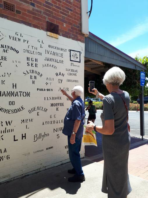 Kaniva district farmer Ron Hobbs points out his wool stencil to visitors at Kaniva's stencil wall. Photo by Helen Hobbs.