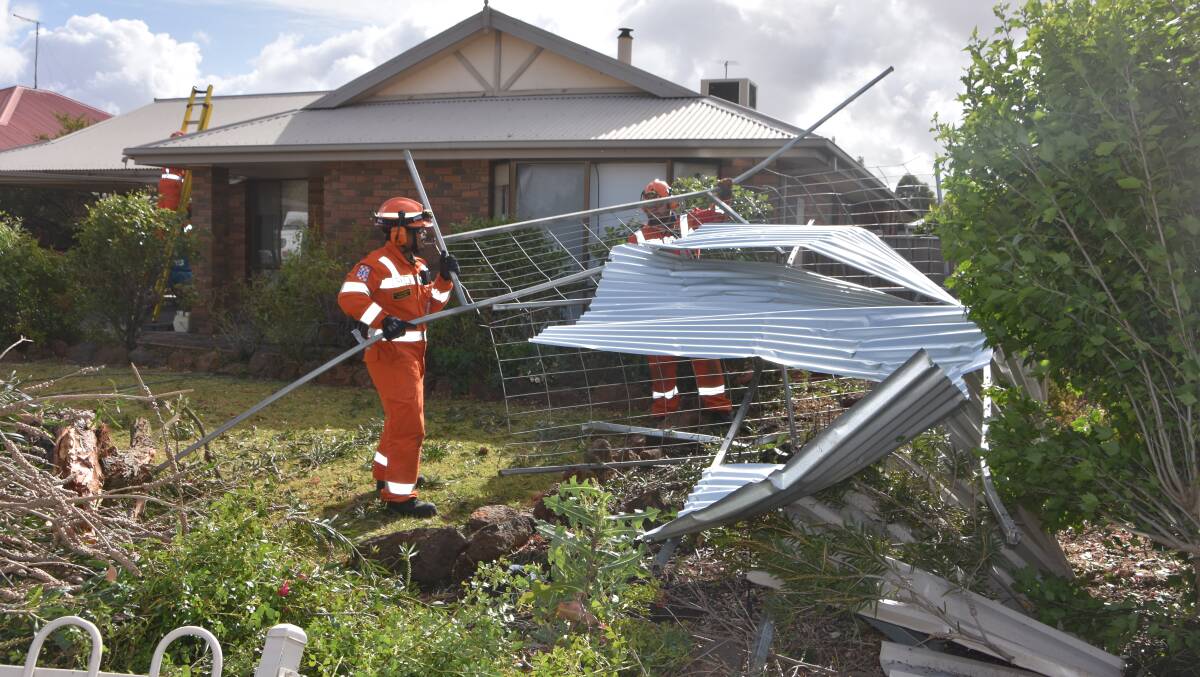 Nilo Polkinghorne and John McKenzie of the Hamilton State Emergency Service attend to the clean-up in the wake of wild weather in Francis-st, Horsham on Monday morning. Photo: Gregor Heard.