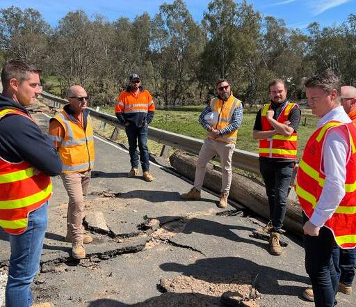 Roads Minister Ben Carroll (right) examines damage to the McIvor Highway, Axedale. Picture supplied by the Department of Transport.