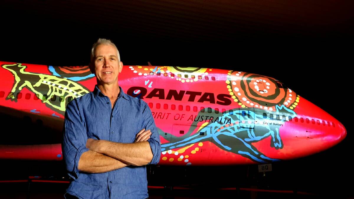 Qantas Founders Museum CEO Tony Martin with the artwork of Wunala Dreaming by Balarinji.