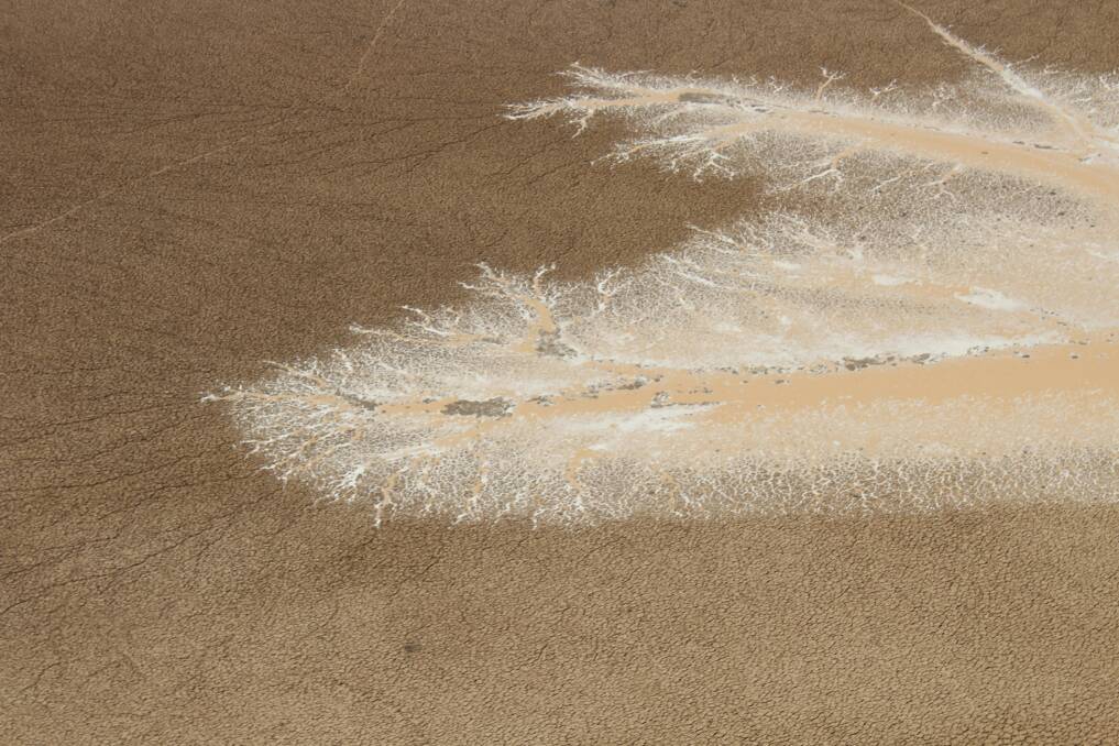 Tendrils of flood water creeping across the dry plains at Davenport Downs.