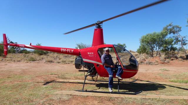 Leon Christiansen with one of the helicopters he's used in the years since he became licensed. Picture supplied.