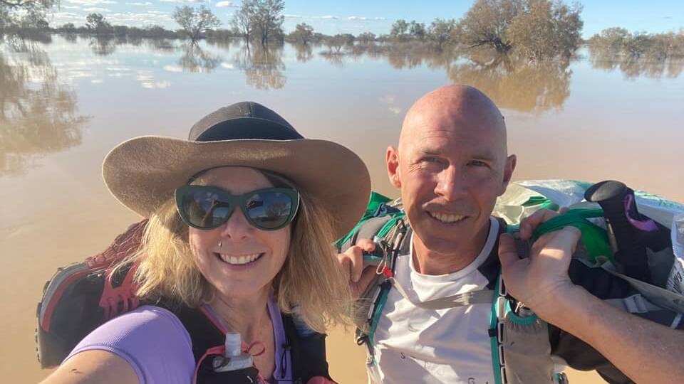 With hydration vests and running shoes slung over their shoulders, Vanessa Bond and Michael Greenep take the 'scenic SES river cruise' across the Diamantina.