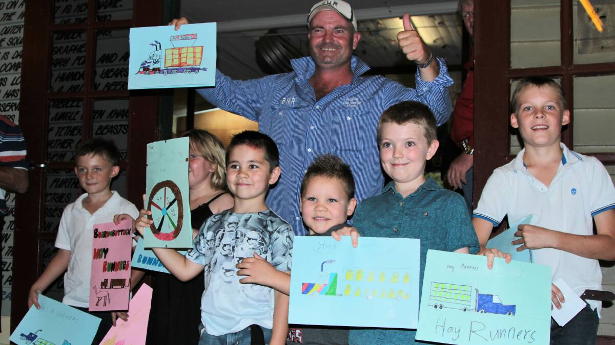 Job well done: Children from the Ilfracombe State School present thank you cards to Brendan Farrell, Burrumbuttock Hay Runners organiser. Picture: Sally Cripps.