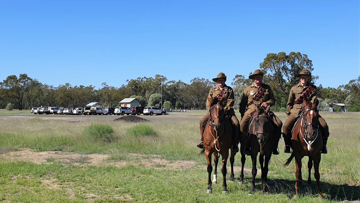 Members of the 11th Light Horse Roma troop, Sandy and Greg Stewart and Hayley Forbes, prepare to take part in the Australia Day dedication activity at Gunnewin's WWI soldier settlement memorial.