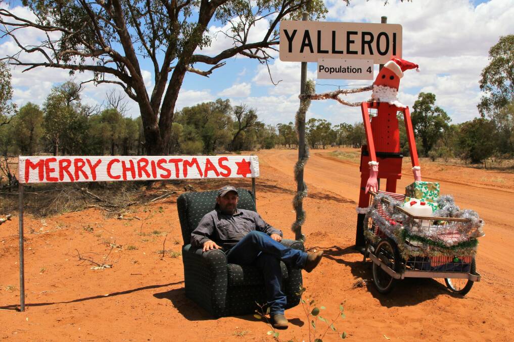 Santa snap: The creator of the two metre Santa greeting drivers as they approach Yalleroi, David 'Crocker' Arnold, tries out the mystery chair. Picture: Sally Cripps.