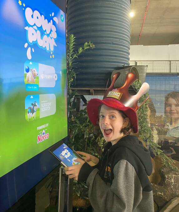 Olivia O'Reilly plays with the Cows Play game at the Ekka in August, where the game was launched in the Norco Grass to Glass activation. Picture supplied
