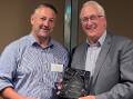 ADIC chair Ben Bennett presents the 2023 Pat Rowley Outstanding Service Award to Terry Richardson. Picture supplied