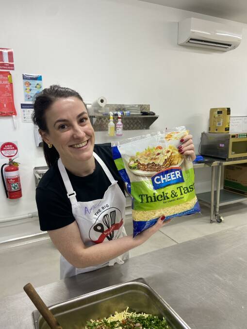 Amelia Hess helps prepare a meal as part of Saputo's community-based initiative. Picture supplied