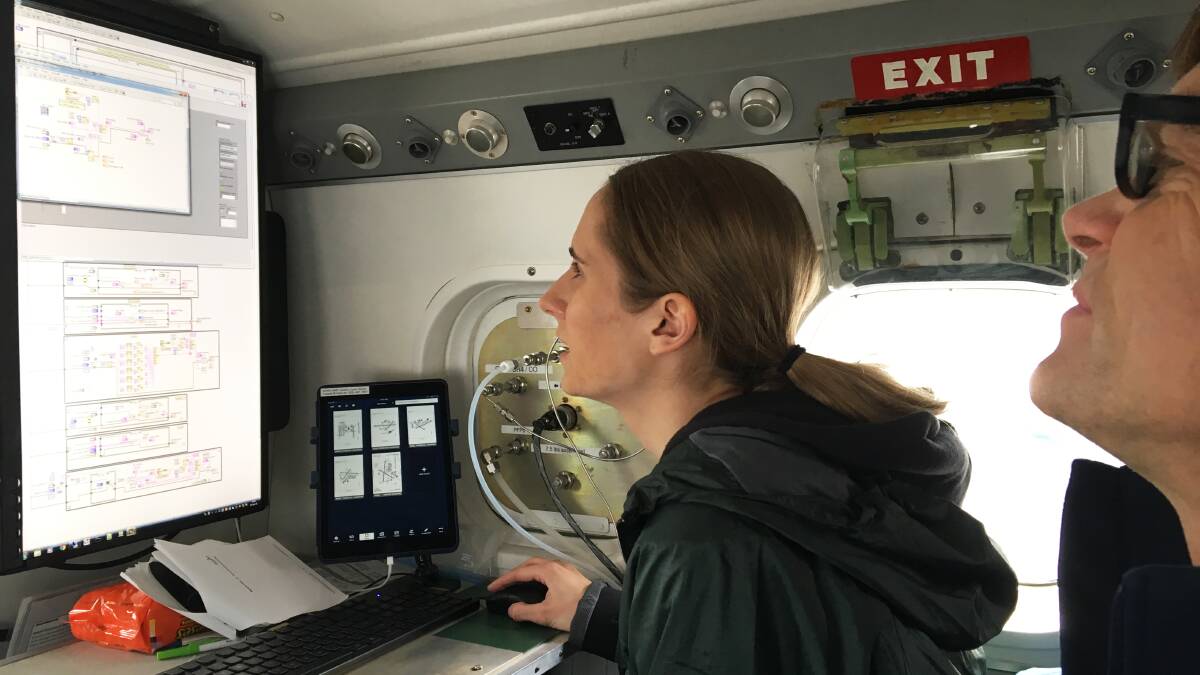 MEASURING METHANE: Genevieve Plant, the University of Michigan, and Colm Sweeney, National Oceanic and Atmospheric Administration, review measurements of methane and other gases during an airborne research project in 2018.