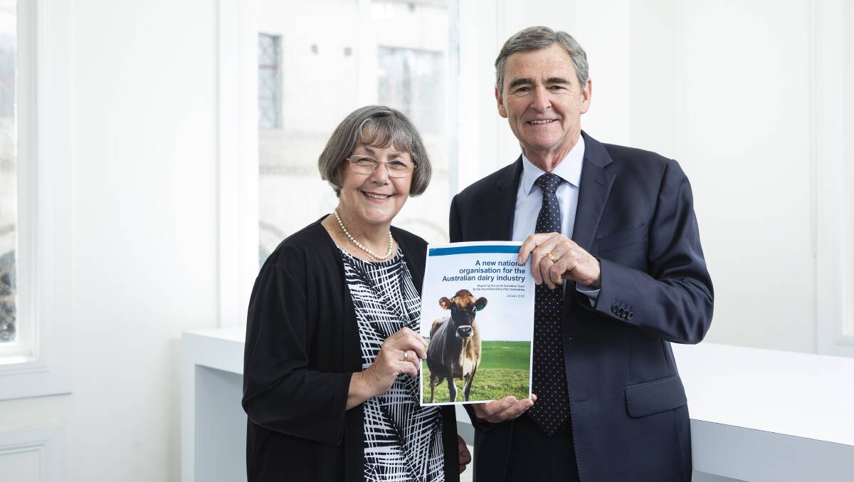 PLAN: Joint Transition Team chair Shirley Harlock hands Australian Dairy Plan independent chair John Brumby a copy of the report recommending a major shake up for the Australian dairy industry.