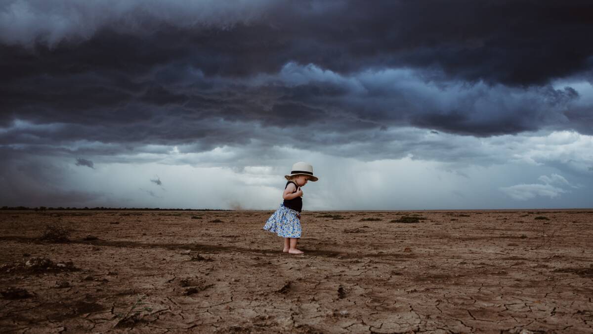 THE INCOMING STORM: 18-month-old Francesca Hick, Antrim Station, south of Hughenden. Photo by Lindy Hick Photography. 