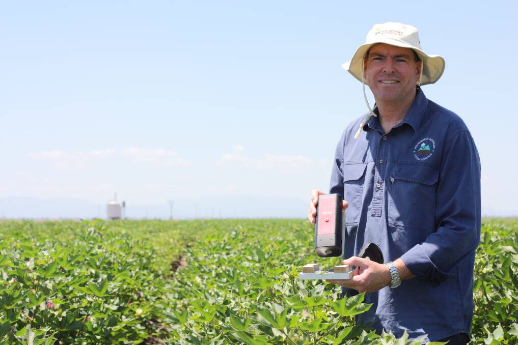 CSIRO team leader and senior research scientist Dr Tim Weaver uses a Hone sensor to scan cotton petioles at strategic growth stages as part of the process of ground truthing satellite imagery for the app.
