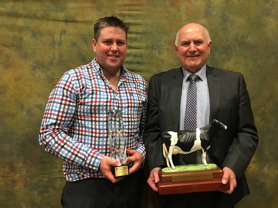 Glen Gordon of Gorbro Holsteins (left) with Graeme Gillan, CEO Holstein Australia, with the Cow of the Year trophies.
