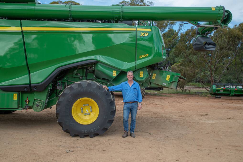 Mr Hosking with the new harvester. 