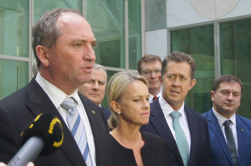 Barnaby Joyce (left) fronting his party at a media conference in Canberra.