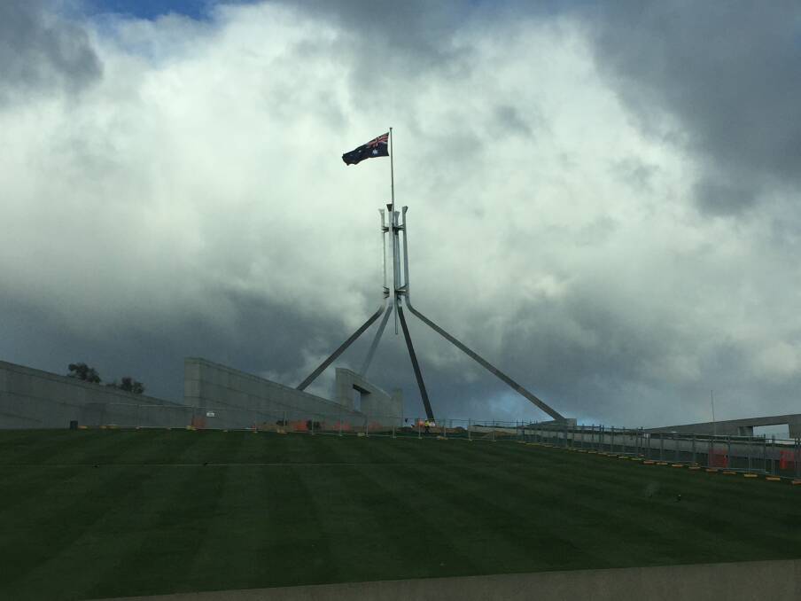 Storm clouds gathering over Parliament House in Canberra with Coalition country members fighting for recognition and power, between Libs and Nats.