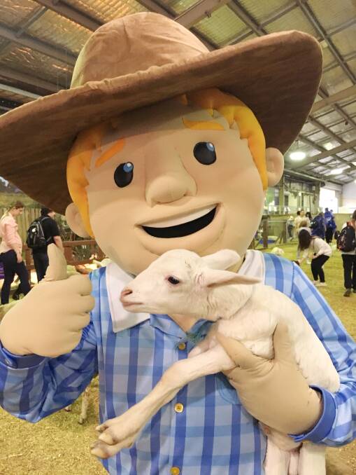 AG MATE: George with a lamb in the food farm at the Sydney Royal Easter Show.