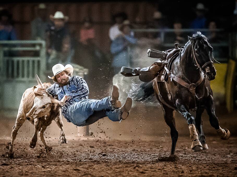 ACTION: Lachlan O'Neill and Caddie cover two head in 7.85 secs to take home the 2016 Mount Isa Rotary Rodeo Steer Wrestling Buckle. Picture: Stephen Mowbray