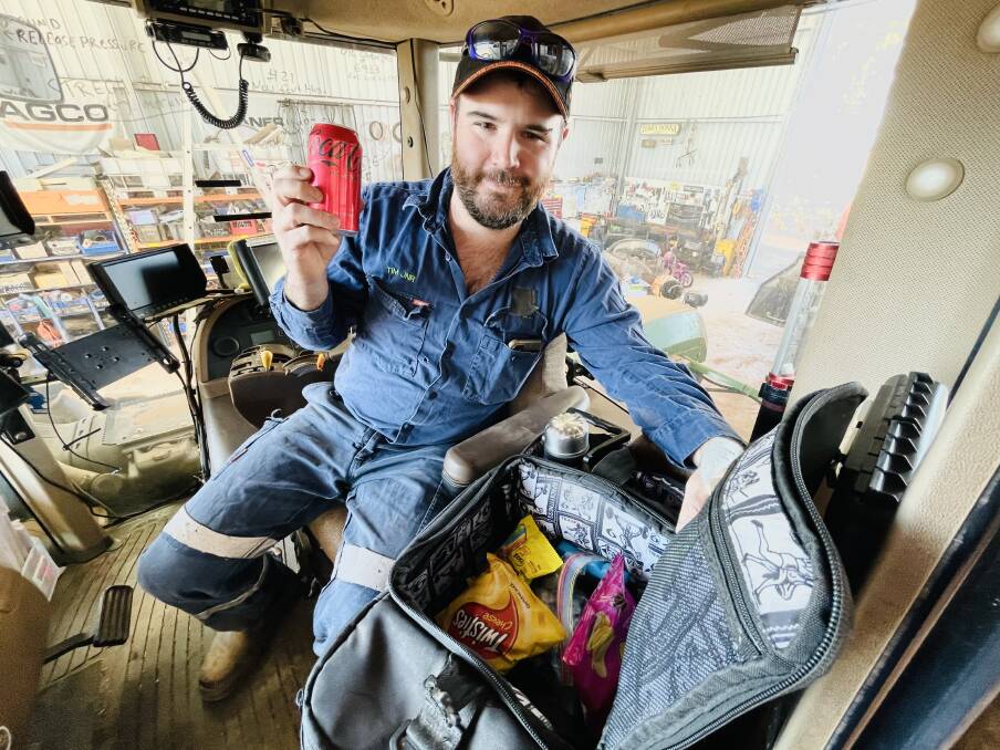 Farmer and TikTok sensation Tim Barndon holds up the sneaky Coke that is always a talking point in his daily lunch box documentaries. With seeding underway he will be in the tractor cab a lot in coming weeks.