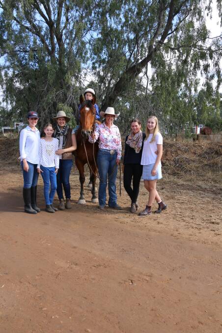 Family of the purchasers, Lucy Thomson, Lydia Williams, Amy McCosker, Lindy Kehl, (vendor) Meg McCosker, Marcella Williams and Jack Tucker riding "Pete"