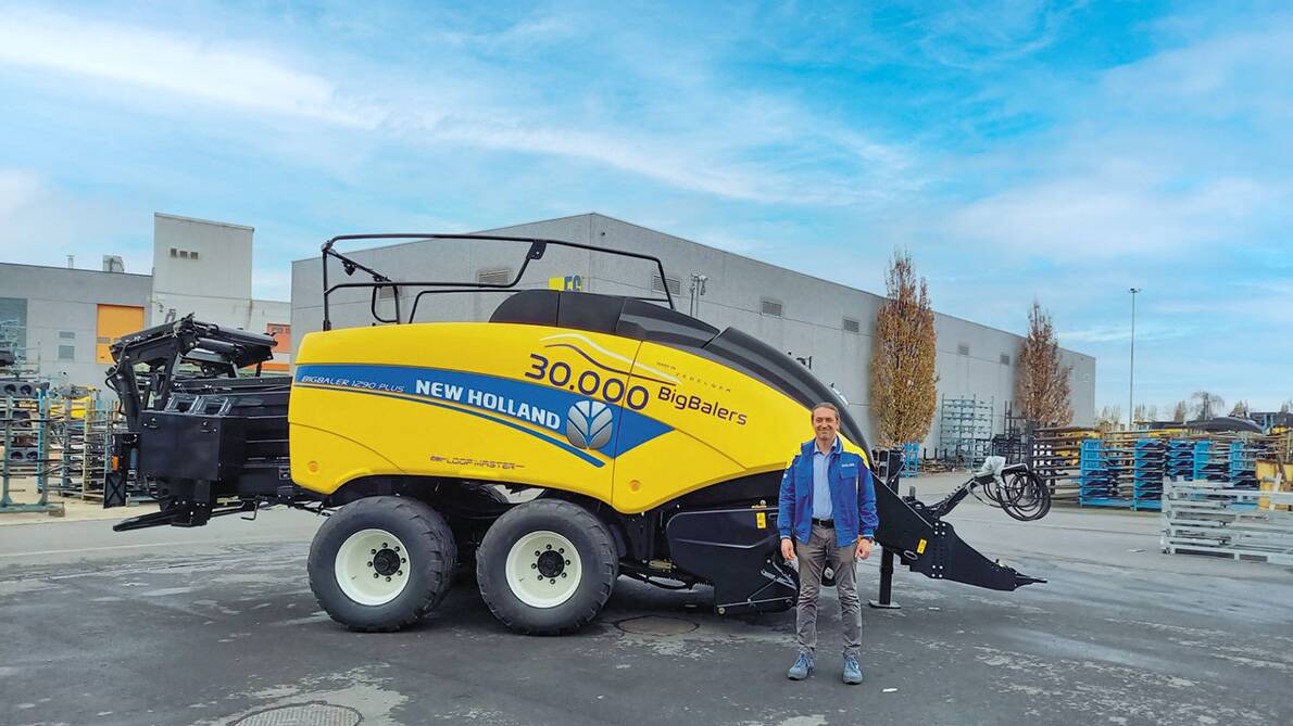 MILESTONE MAN: Luigi Neirynck, New Holland plant manager at Zedelgem, stands with the 30,000th large square baler rolled off the line at the Zedelgem Centre of Harvesting Excellence. 