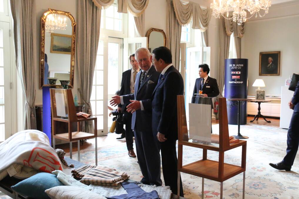 THE HEALTHY FIBRE: Prince Charles talks wool with Japan's Deputy Prime Minister, Taro Aso, at the British Embassy in Tokyo. 