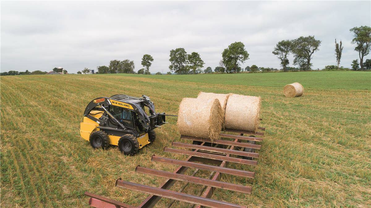 MIGHTY HANDY MACHINE: New Holland's L35 skid steer loader can do many jobs on farms with the addition of labour-saving tools. 
