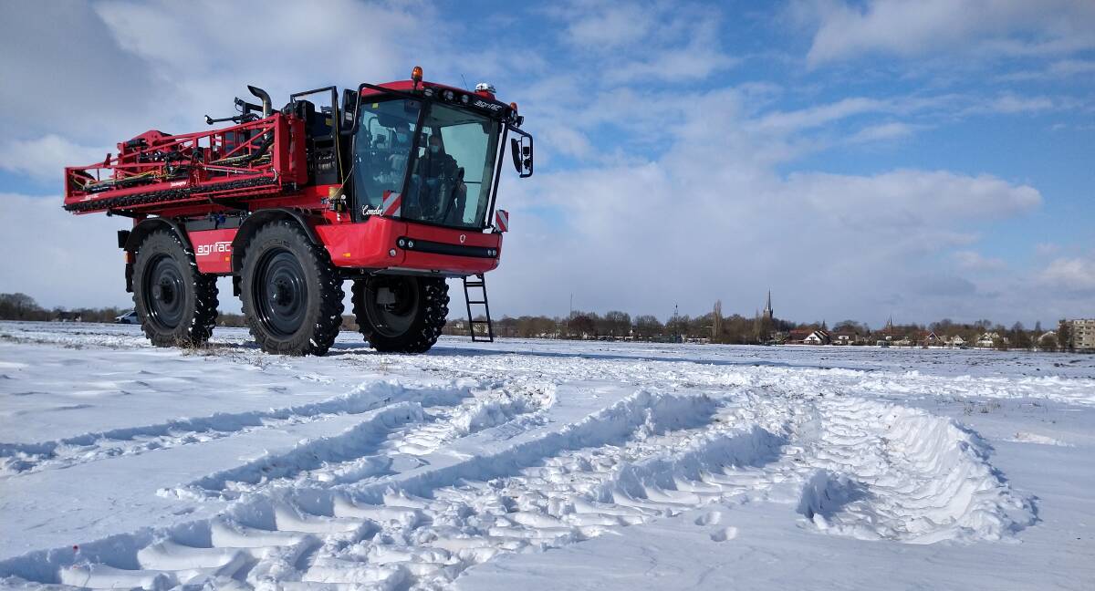 DYEING TO GO: The Agrifac self-propelled sprayer red to "paint" the snow-covered field. 
