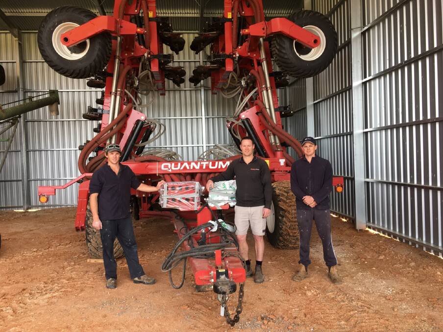 QUANTUM LEAP: Cummins growers Mitch and Brock (right) Jolly with Rob Shirley, Ramsey Bros Cummins, and one of the family's Morris Quantum air drills.
