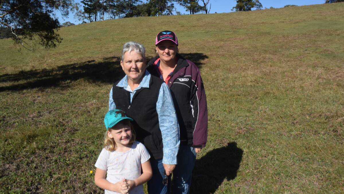 Dianne Love with her daughter Helen Bryce and granddaughter Chelsie on a hillside in the Tweed Valley affected by die-back. Normally tropical grasses are up to the second wire in this paddock. What has grown back is dominated by legumes and herbs.