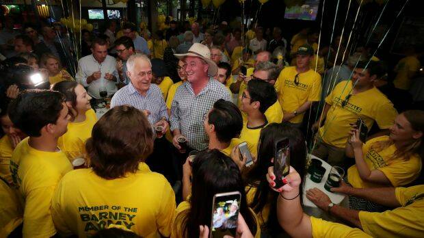 Prime Minister Malcolm Turnbull and Barnaby Joyce celebrate his re-election with National party supporters. Photo: Alex Ellinghausen