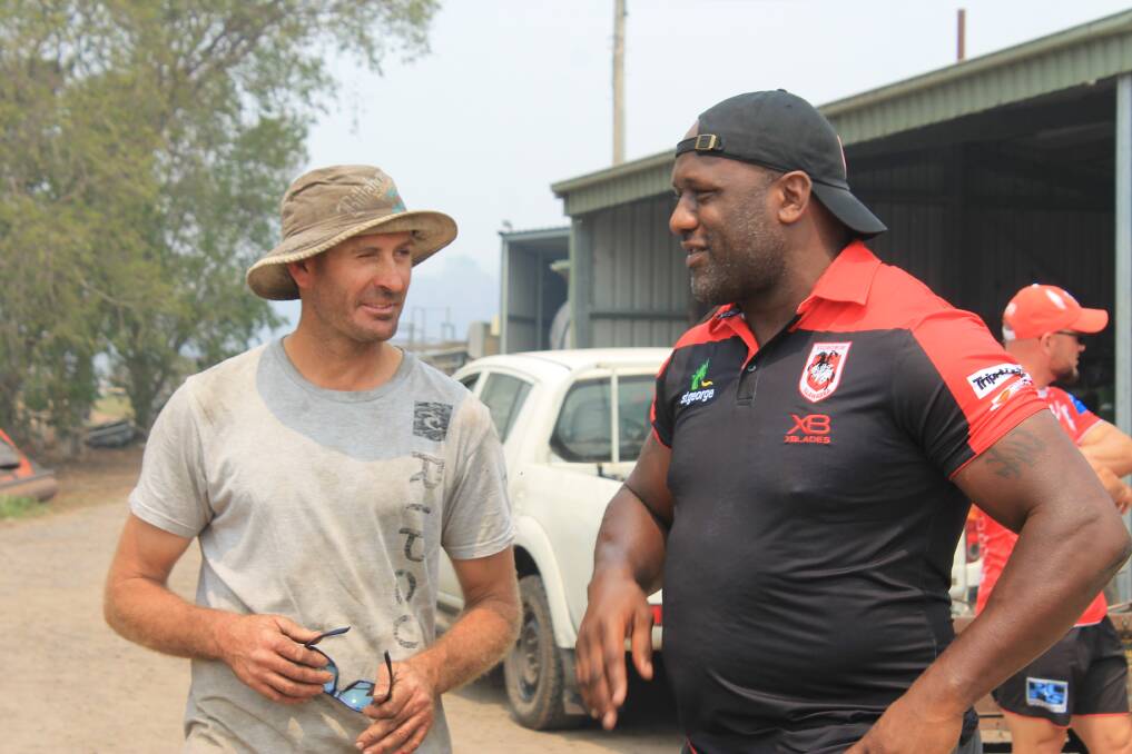 HERE TO HELP: Brett Jessop chats to Wendell Sailor when the St George Illawarra Dragons visit his farm on Wednesday. Picture: Albert McKnight 