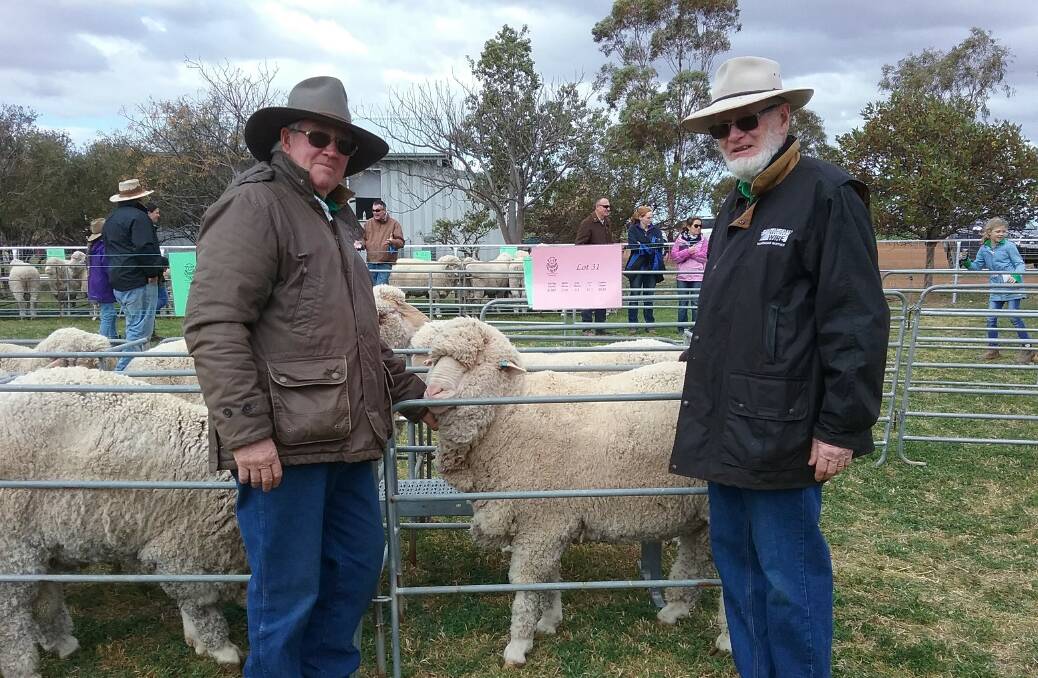 Ballatherie stud principal, Geoff Peters with the charity pen ram who sold for $2,250 to John McKeon, Hillston. The proceeds of the ram's sale will go to Hillston Can Assist. Photo supplied.