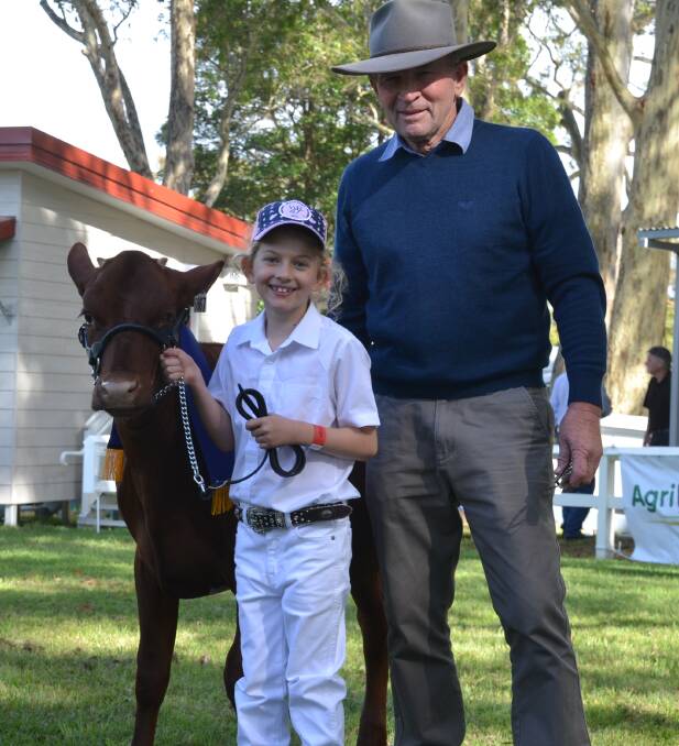 GOOD WIN: Six-year-old Lucy Cochrane leading Kangawarra Elaine took out the under 10s junior paraders. She is pictured with the chief cattle steward and proud grandfather Alan Garratty.

