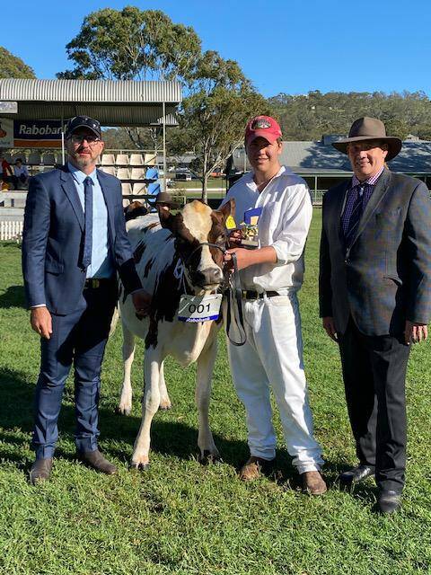 Judge Travis Deans, grand champion young parader Kian Verrall and dairy chairman Wayne Bradshaw. 