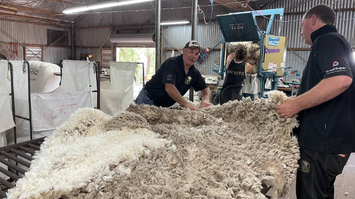 TRAINING GROWTH: Wool classer trainer Paddy McCarthy sharing tricks of the trade at a SCAA Shearer Woolhandler Training course. 