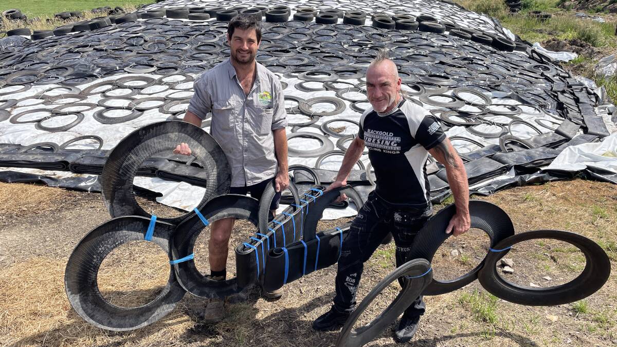 Westbury dairy farmer Stuart Griffin and former fencing contractor turned inventor Peter Singleton hold two Manbags and the sidewalls of reused tyres. Picture by Bryce Eishold