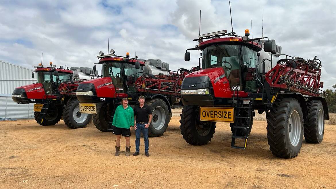 Corinella Farms operating partner Sue Watson and Ritchie Bros agricultural territory manager Gary Biggs in front of three 2016 to 2020 Case IH 4430 Patriot sprayers. 