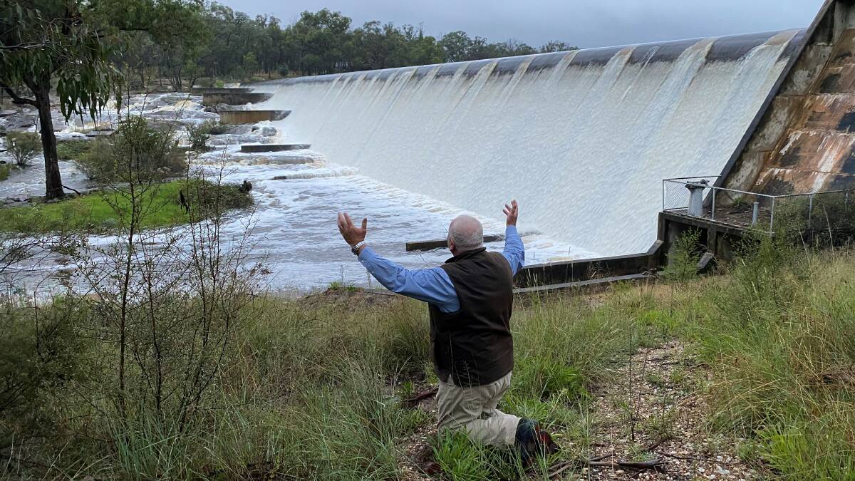 Southern Downs Mayor Vic Pennisi celebrates the water flowing into the Storm King Dam. 