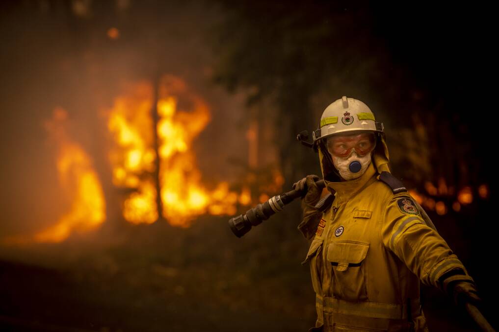 Stacey Wilson from the Milton Volunteer Rural Fire Brigade at the bushfire front on Murramarang Road in Bawley Point on December 5, 2019. Picture: Sitthixay Ditthavong