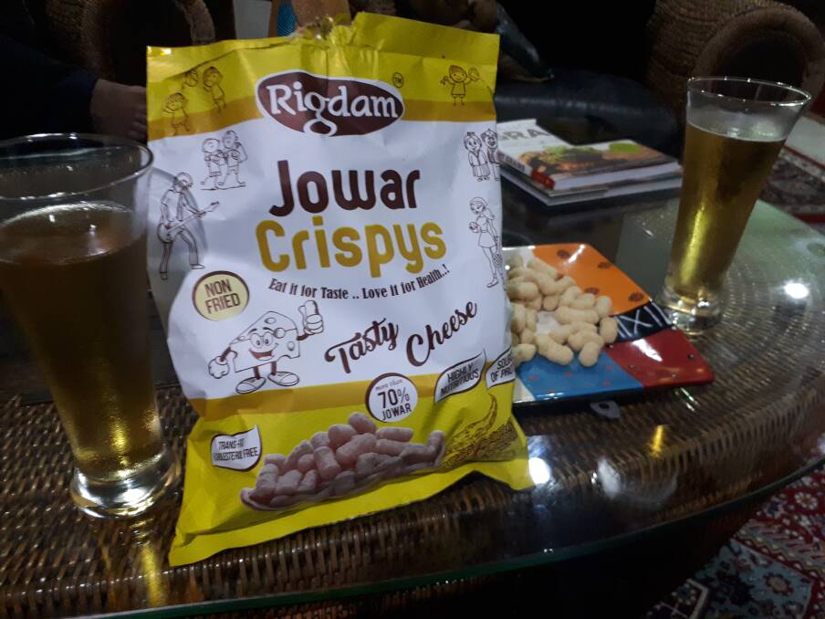 Indian sorghum snacks, served with a millet beer.