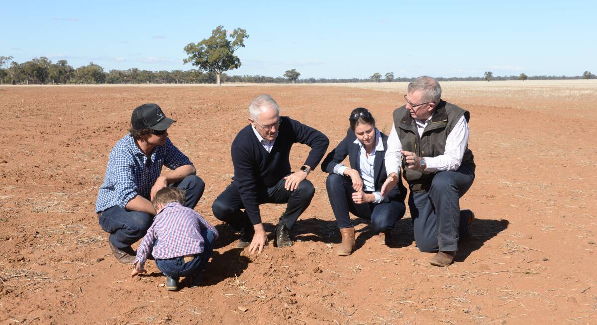 Malcolm Turnbull and Parkes MP Mark Coulton talk with the Miles family of "Strathmore", Trangie, NSW during the PM's recent drought "listening tour".