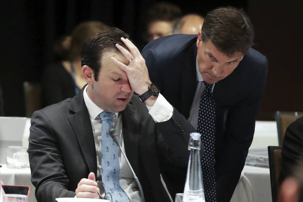 Doh!: Resources Minister Matt Canavan and Energy Minister Angus Taylor in discussions during the COAG Energy Council Council meeting in Adelaide on Wednesday December 19. Photo by Alex Ellinghausen.

